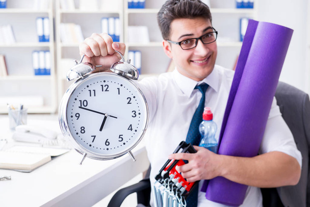 Businessman rushing to sports with clock - Photo, Image