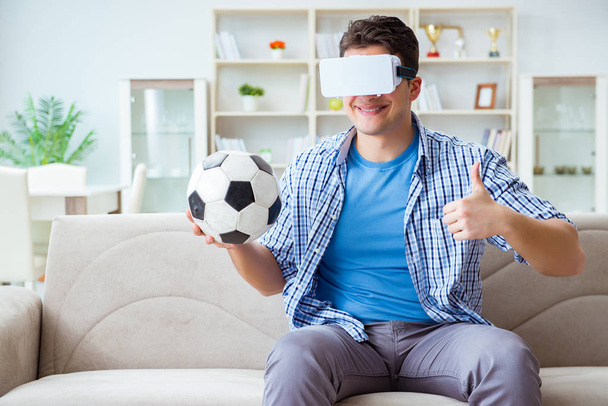 Man wearing virtual reality VR glasses watching soccer football - Photo, Image