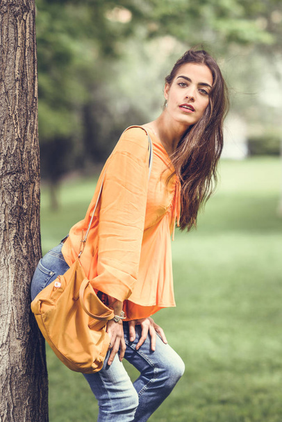 Woman with nice hair wearing casual clothes in urban background. - Photo, Image