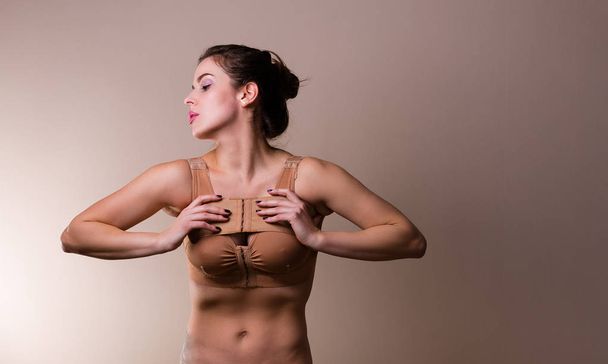 Nainen yllään puristamalla rintaliivit
 - Valokuva, kuva