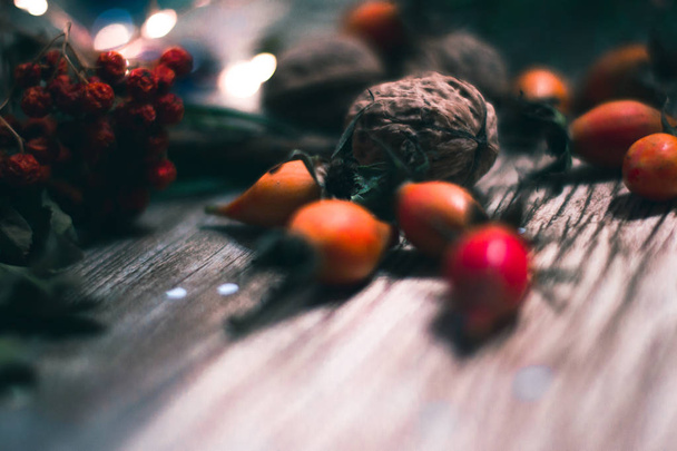 Berries and nuts on wooden boards with a blurred background. - 写真・画像