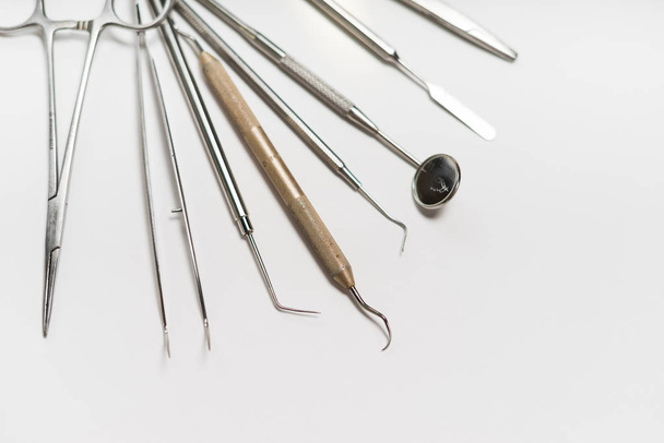 on the white surface are medical dental instruments - Фото, зображення