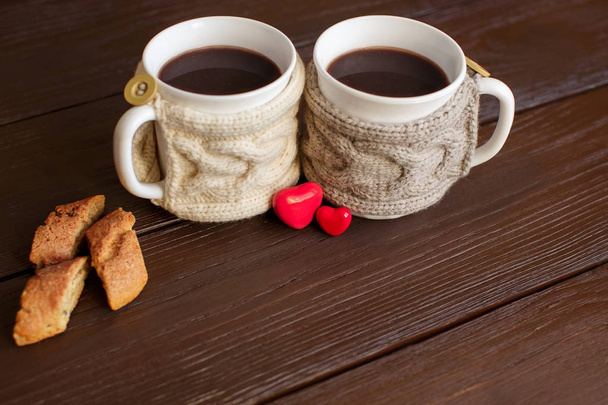 Tazas de café con portavasos de punto cerca del corazón para el día de San Valentín. Café de amor
 - Foto, imagen