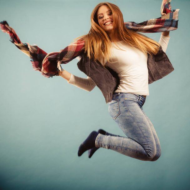 Woman fashion autumn girl jumping, flying in air on blue - 写真・画像