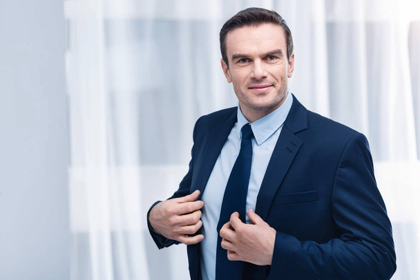 Attractive promising man  trying suit - Foto, immagini