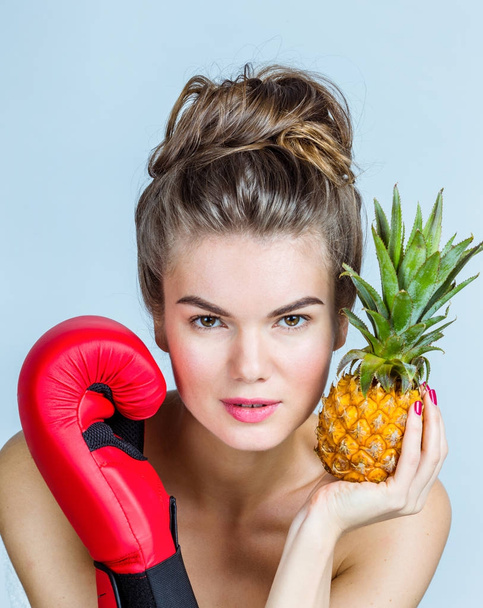 Woman with pineapple and boxing glove - Фото, зображення