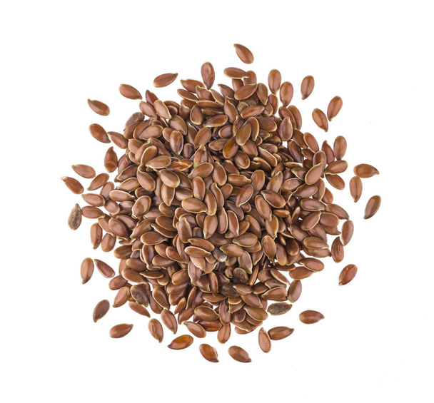 Pile di semi di lino su sfondo bianco, vista dall'alto
 - Foto, immagini