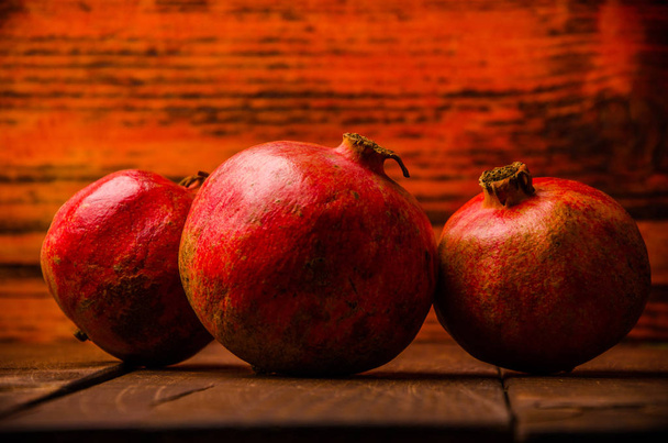 ripe pomegranate on wooden boards. juicy pomegranate on wooden boards. - Valokuva, kuva
