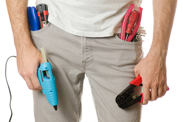 Man in a pocket constructing tools - 写真・画像