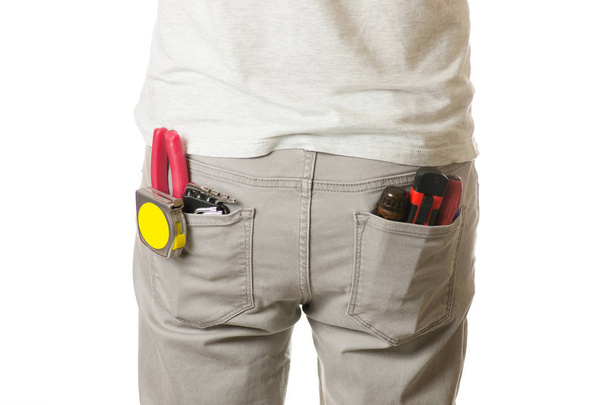 Man in a pocket constructing tools - Foto, Bild