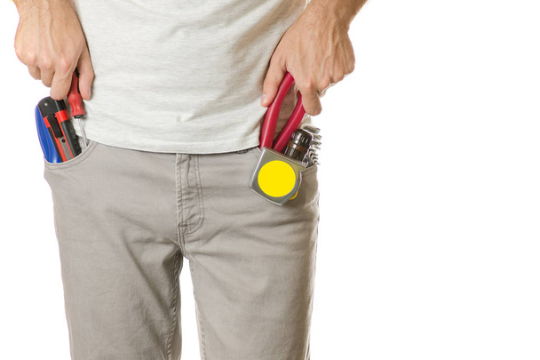 Man in a pocket constructing tools - Foto, imagen