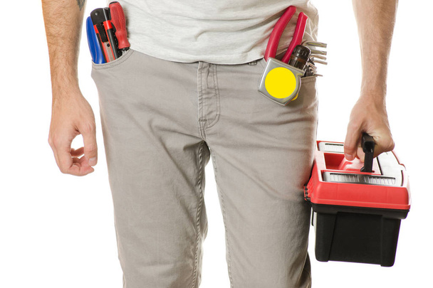 Man in a pocket constructing tools toolbox - 写真・画像