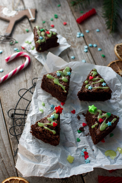 Christmas food ides, delicious chocolate brownies in shape of christmas fir tree on rustic wooden background - Φωτογραφία, εικόνα