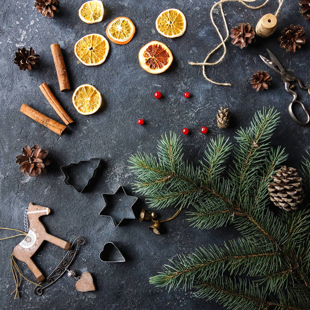 Christmas flat lay home decor, dry oranges, fir tree, cinnamon and cones - Photo, image