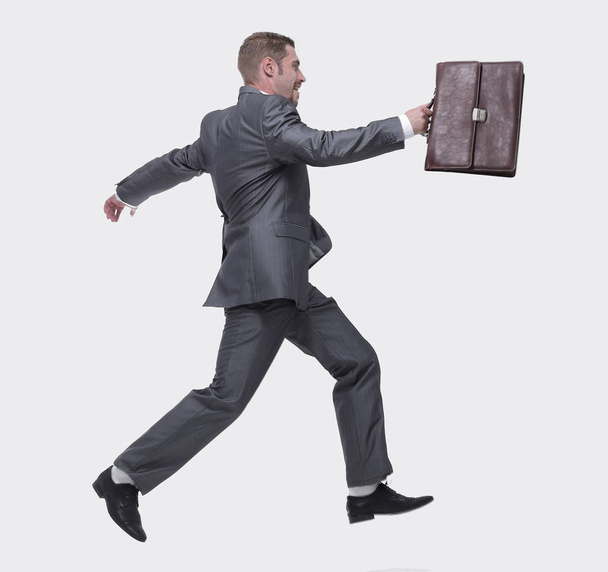 lado view.cheerful hombre de negocios con maletín dando un paso adelante
 - Foto, imagen