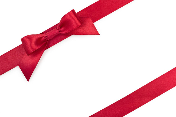 Red satin gift ribbon bow with another ribbon isolated on white  - Fotografie, Obrázek