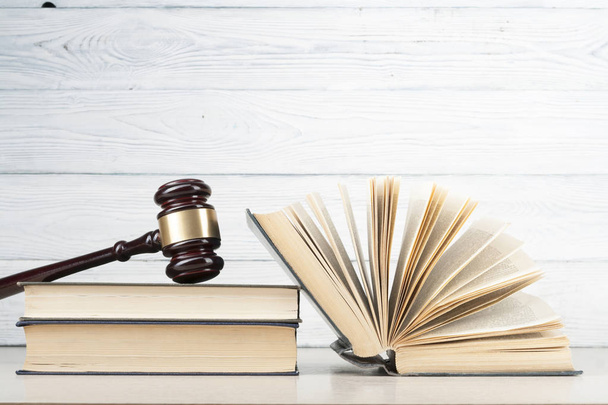 Law concept. Books and wooden court gavel on table in a courtroom or enforcement office. - Photo, Image
