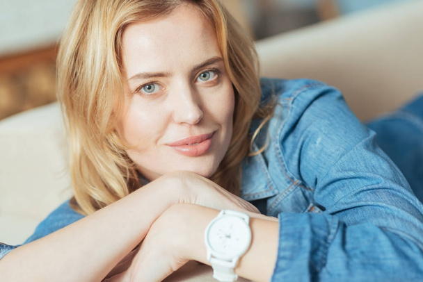Young smart woman feeling confident with her new convenient watch - Fotó, kép