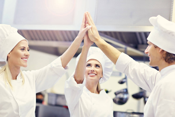 Busy chefs at work in the restaurant kitchen - Foto, imagen