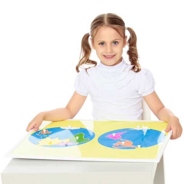 A little girl is studying Montessori stuff. - Photo, Image