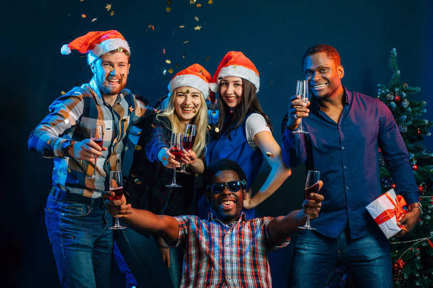 Happy friends with champagne celebrating Christmas - Fotoğraf, Görsel