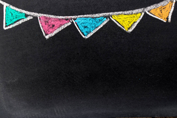 Chalk drawing as colorful party flag on black board background with copy space for decoration or add text - Photo, Image