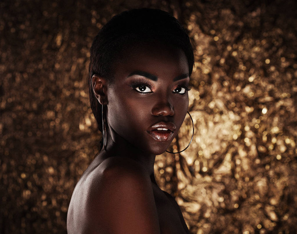 portrait of sensual young african woman against golden background - Φωτογραφία, εικόνα