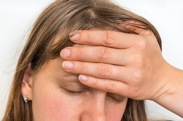 Nainen, jolla on päänsärky pitelee hänen kipeää otsaansa
 - Valokuva, kuva