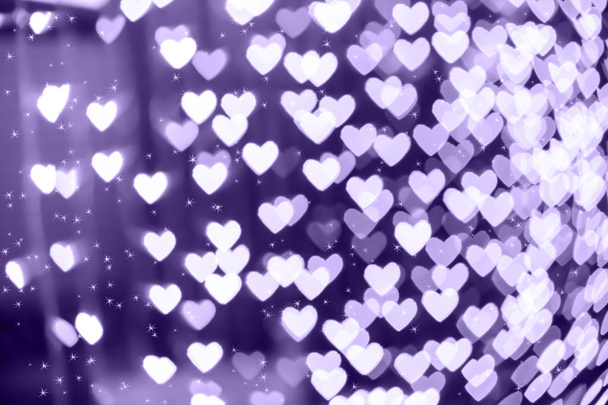 Heart shape blurred bokeh background with sparkles. Ultra violet - Photo, Image