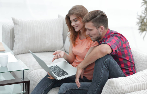 young couple watching videos on laptop - Fotó, kép