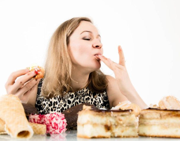 glutton woman eating cupcakes with frenzy after long diet - Фото, зображення