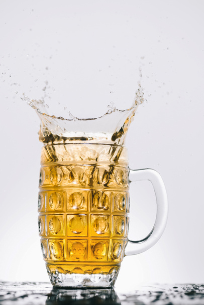 splashes of cold light beer in transparent glass - Фото, изображение
