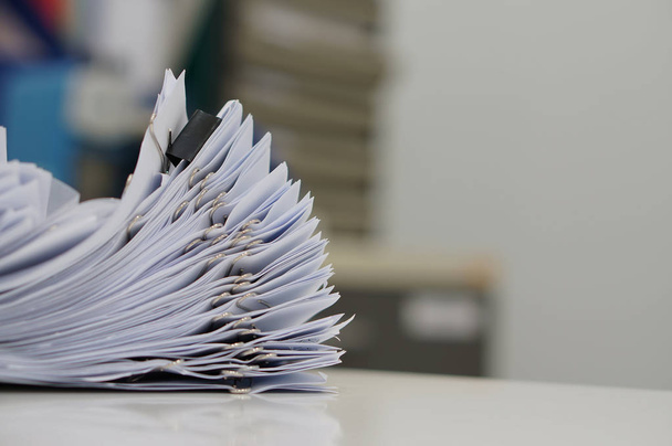 Unfinished document, stacks of paper files with clips on desk - Photo, Image