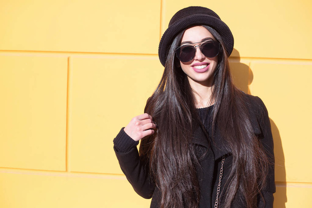Outdoor fashion portrait of glamour sensual young stylish lady wearing trendy fall outfit , black hat , black coat and stylish sunglasses. - Photo, Image