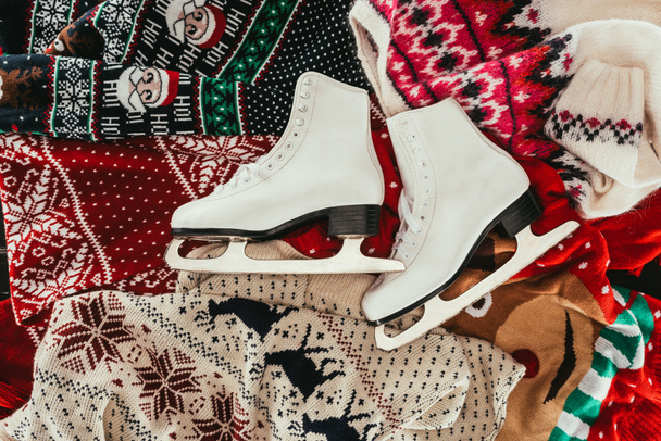 top view of pair of white skates on winter clothes - Valokuva, kuva