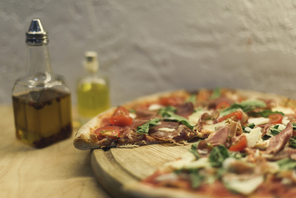 selective focus of tasty homemade italian pizza on wooden board - Photo, Image