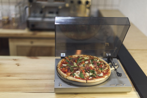selective focus of pizza on vintage vinyl record player - Photo, Image