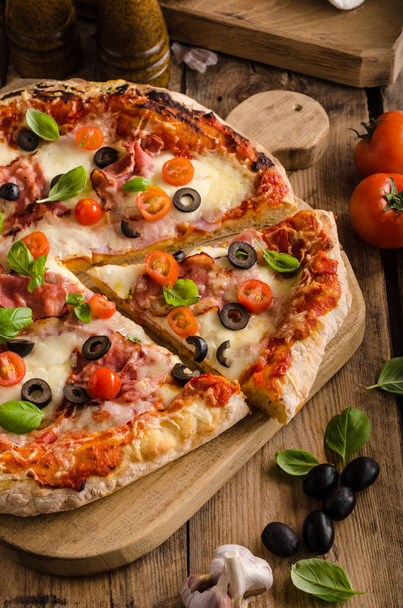Rustic pizza with tomato, cheese, salami - 写真・画像