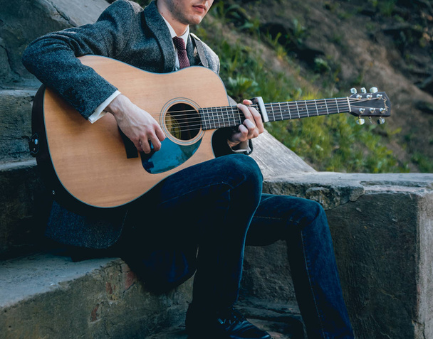 Cropped image of musician playing acoustic guitar. - Photo, Image