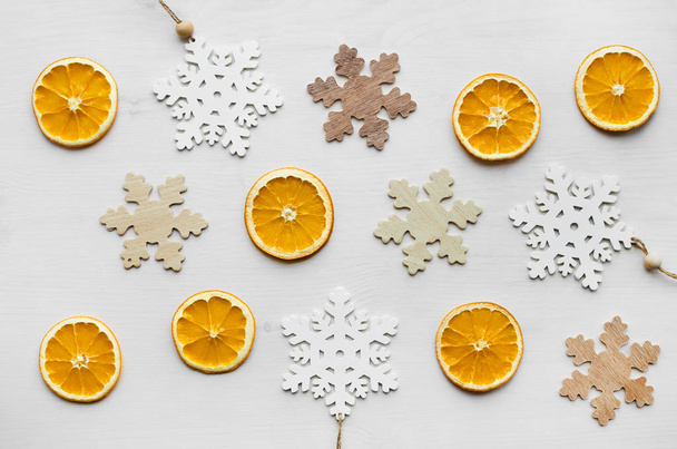 christmas frame composition with dry oranges and wooden snowflakes - Fotografie, Obrázek