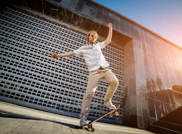 Skateboarder practicing and jumping on the streets - Фото, изображение
