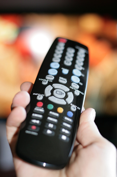 Hand pointing a tv remote control - Φωτογραφία, εικόνα