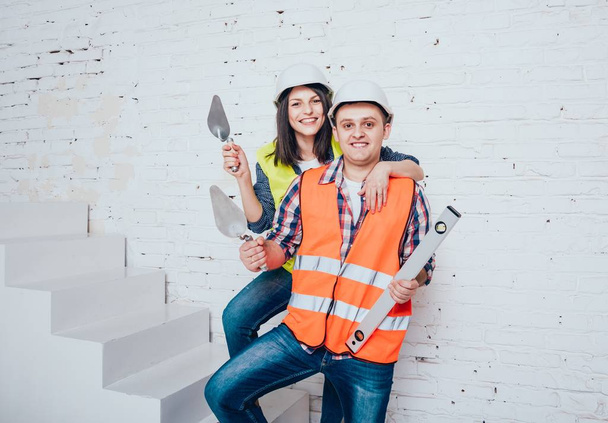 Happy couple making repairs to their home. Home renovation. - Fotó, kép