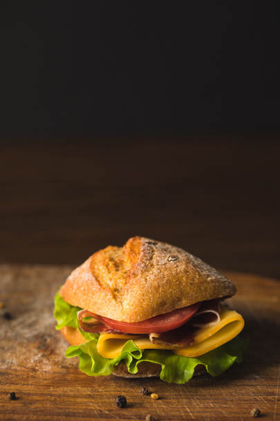 close up view of sandwich on wooden board on table - Фото, изображение