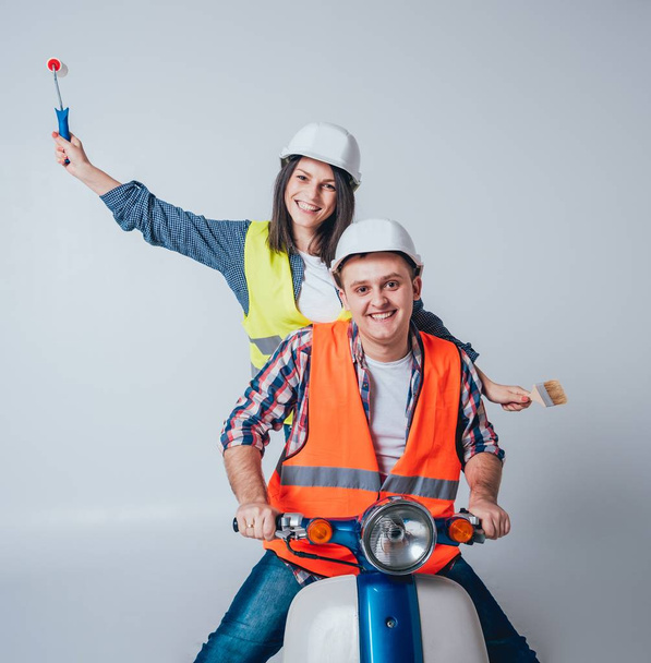 Happy young couple on motorbike. Shopping for the construction and repair for new home concept. - Foto, afbeelding