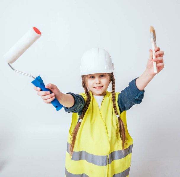 Little cheerful girl with braids playing in repair or construction - Photo, image