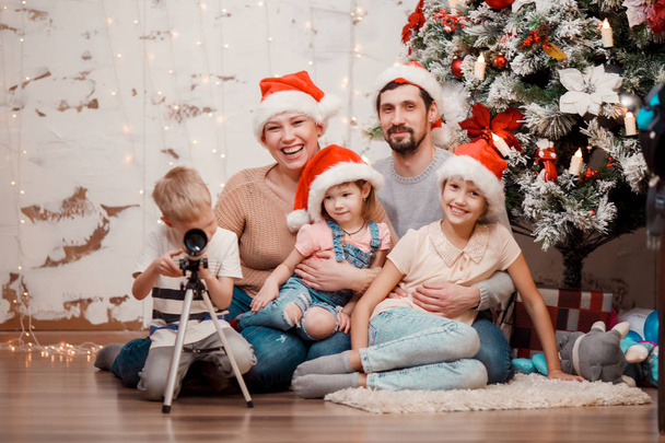 New Years photo of parents, two daughters and son with telescope - Zdjęcie, obraz