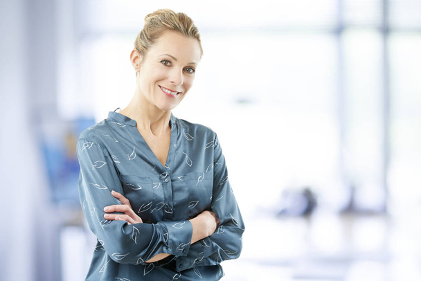 Confident smiling financial advisor businesswoman standing with arms crossed at the office.  - Photo, image