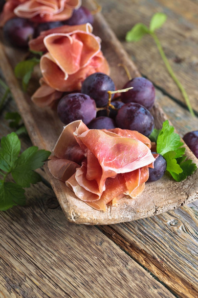 Prosciutto with grape. - Photo, Image