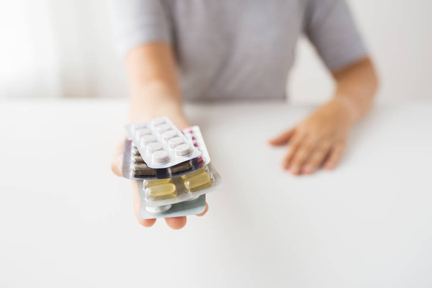 woman hands holding packs of pills - Foto, Bild